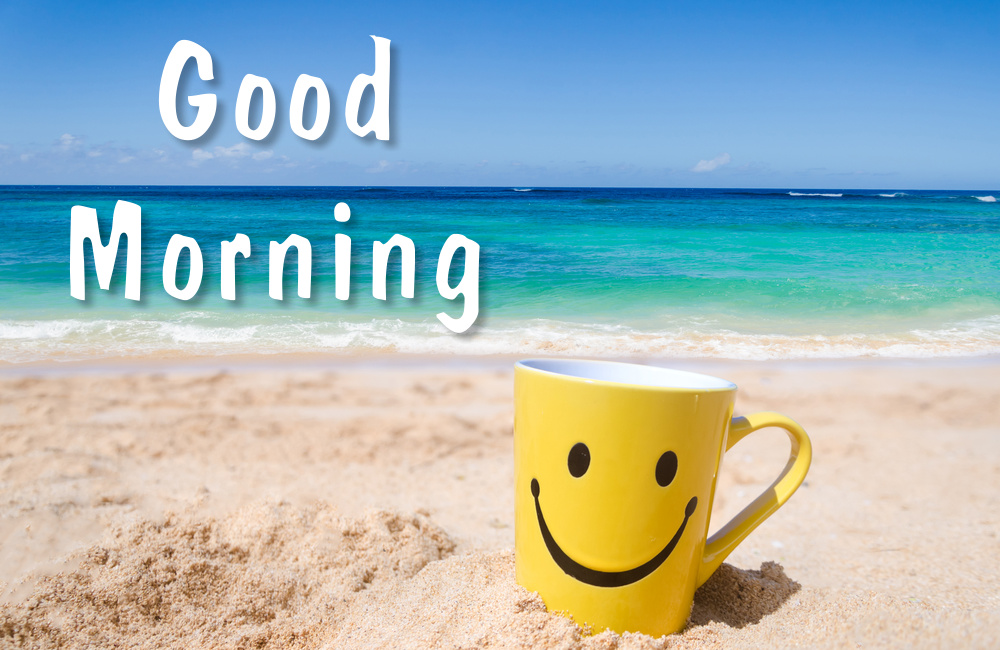 Happy face mug on the sandy beach. Good morning mood.