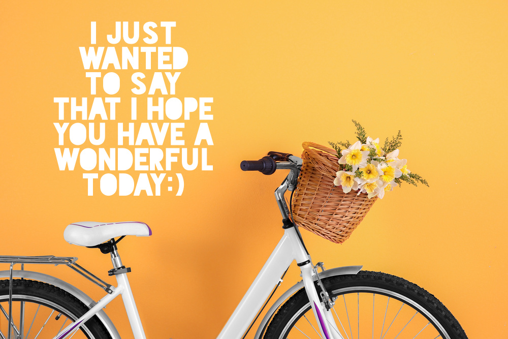 Bicycle with basket of beautiful flowers on color background with positive morning wishes.