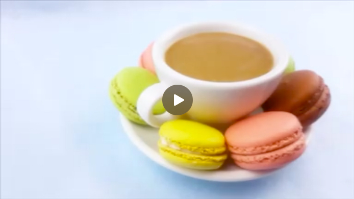 Beautiful cup of coffee with colorful cakes.